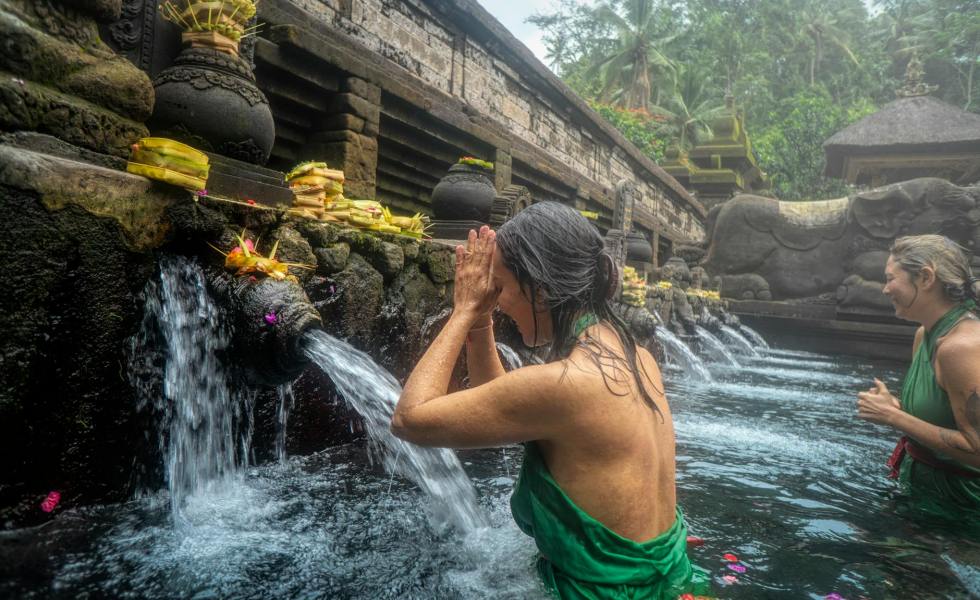 woman standing in front of flowing water