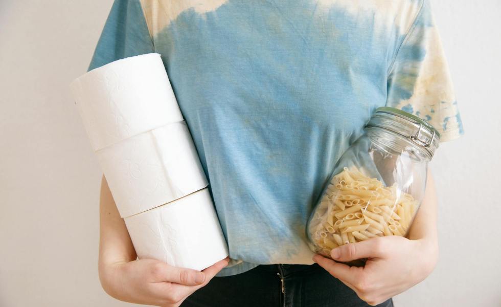 person holding pasta jar and tissue paper