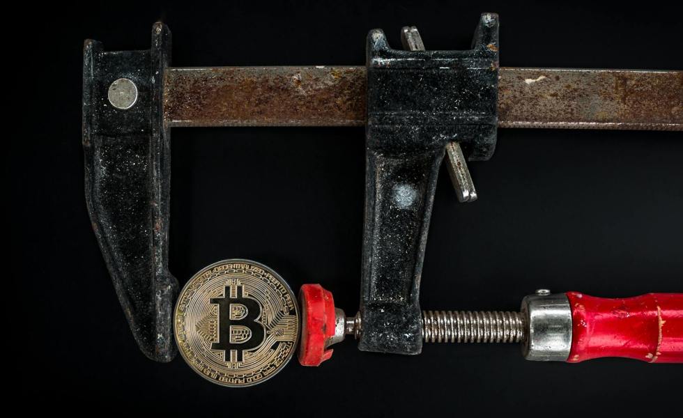black and red caliper on gold colored bitcoin