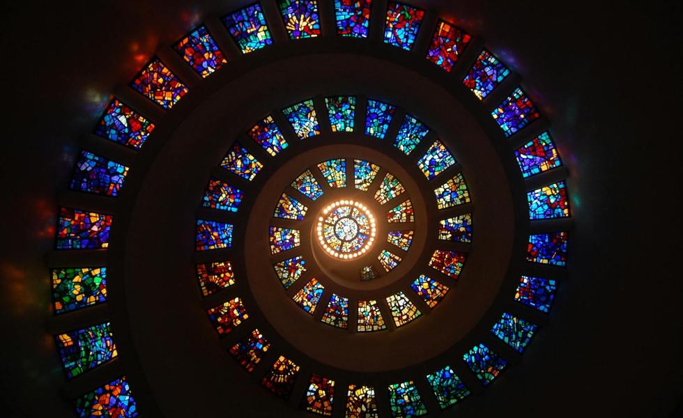 worms eye view of spiral stained glass decors through the roof