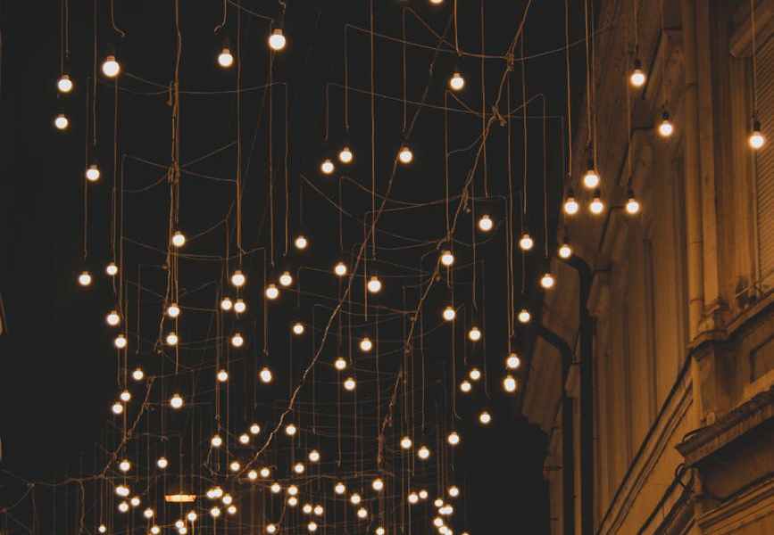 string lights on brown concrete building during night time